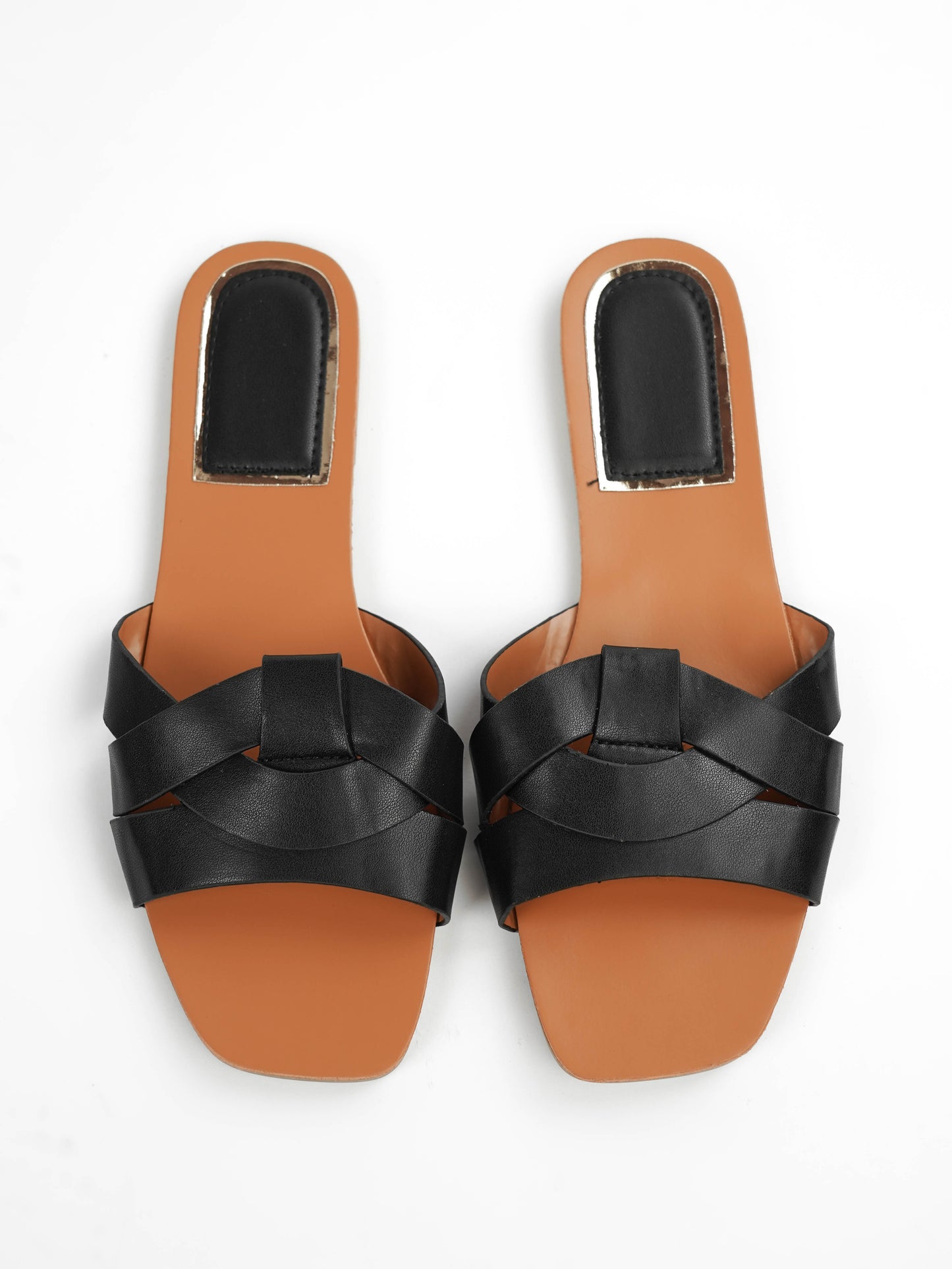 Pair of black sandals with brown soles on a white background