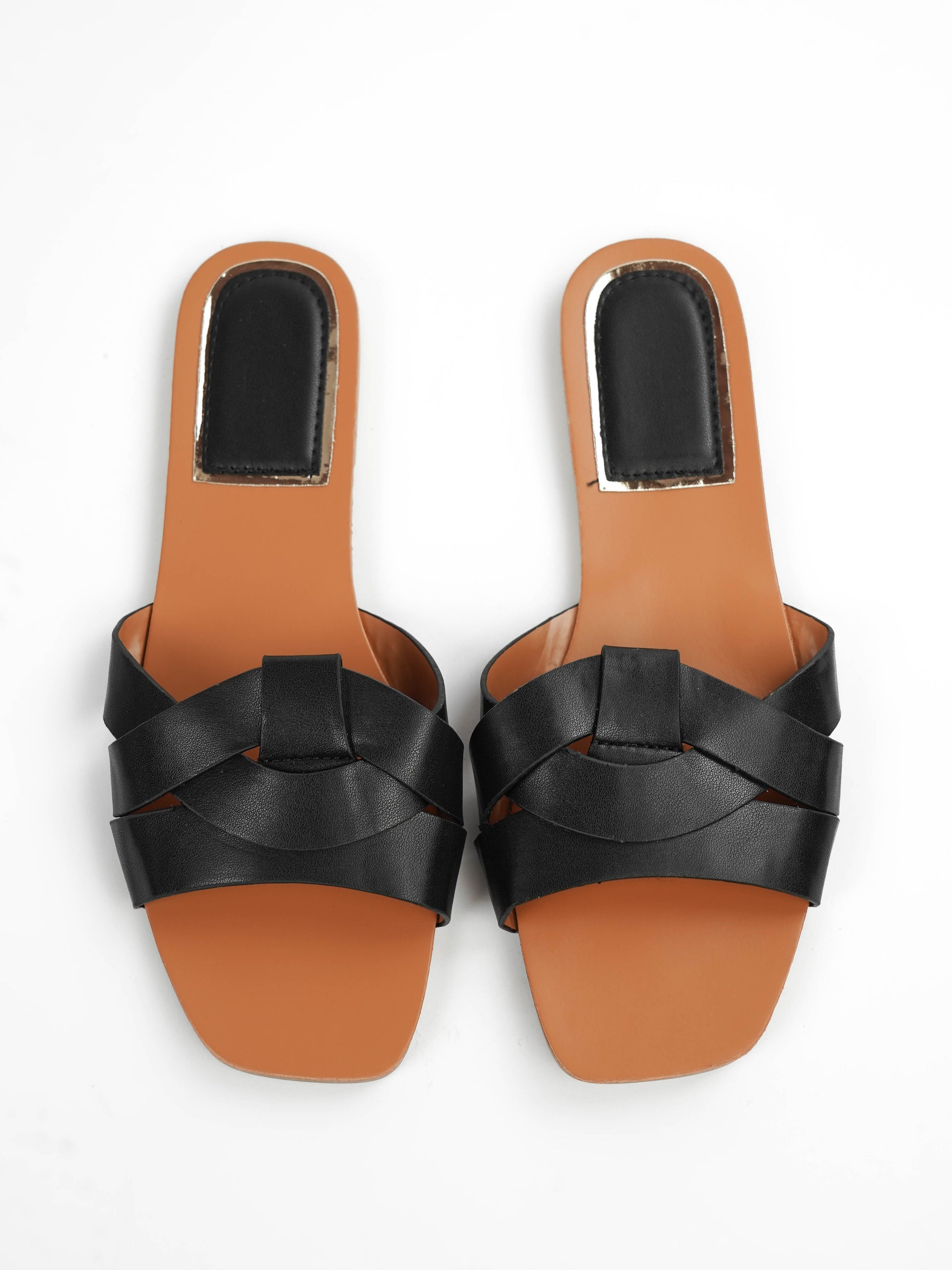 Pair of black sandals with brown soles on a white background